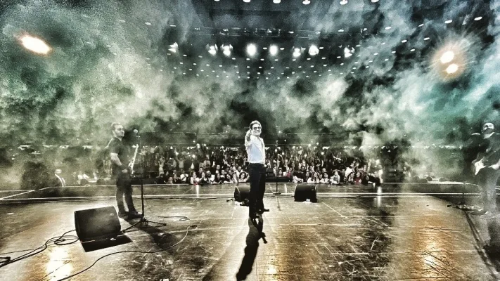 Andy Madadian singing on stage